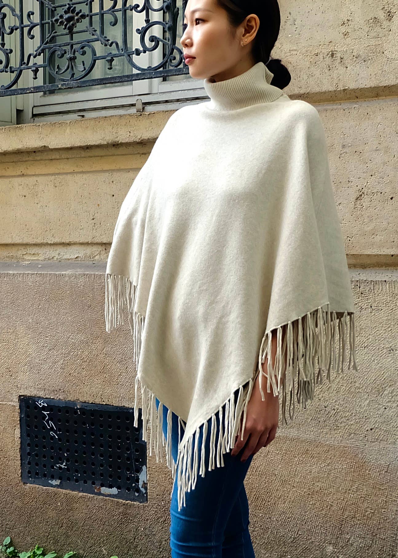 Knit poncho with fringes